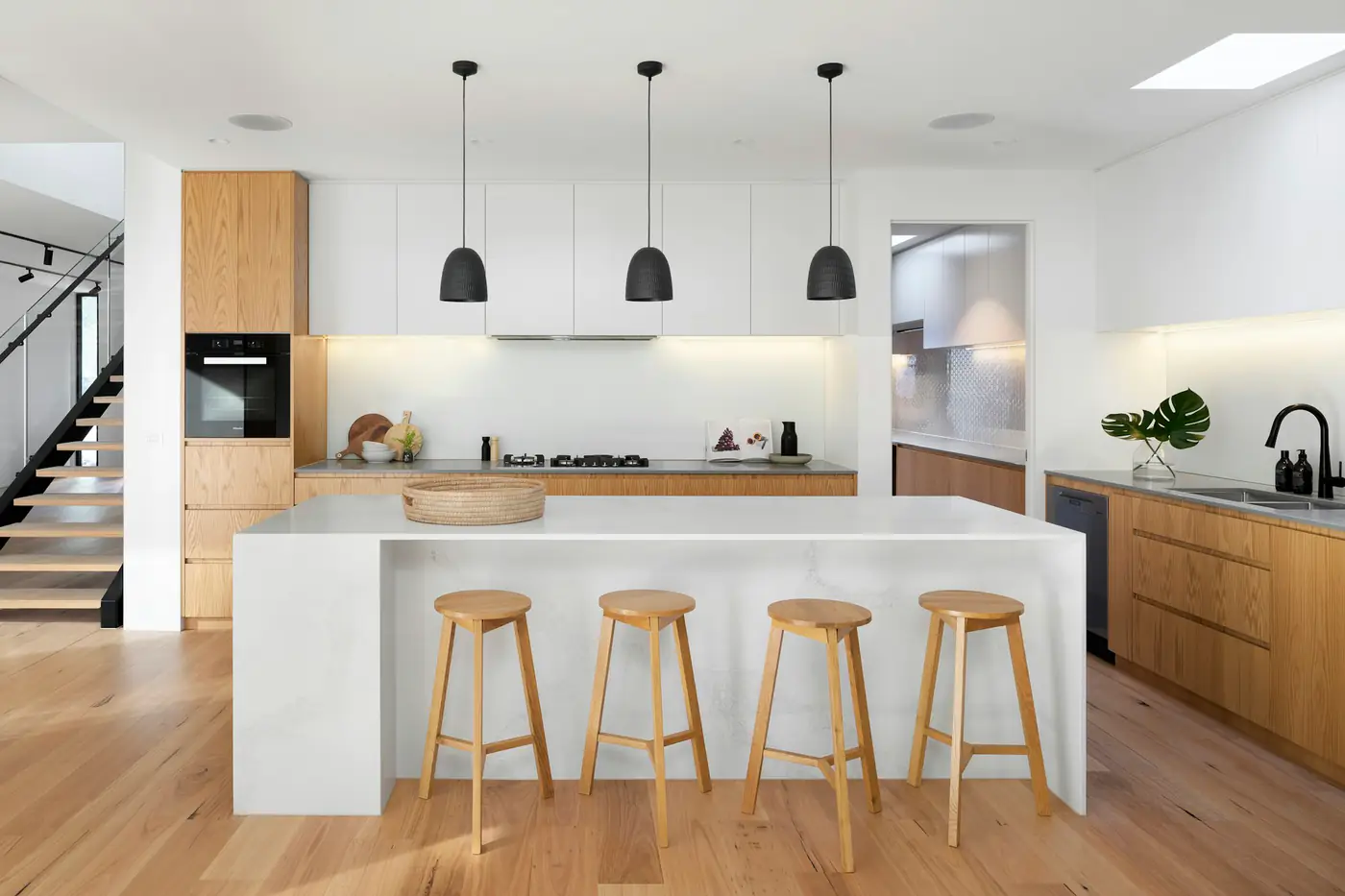 A kitchen with an island and pendant lights