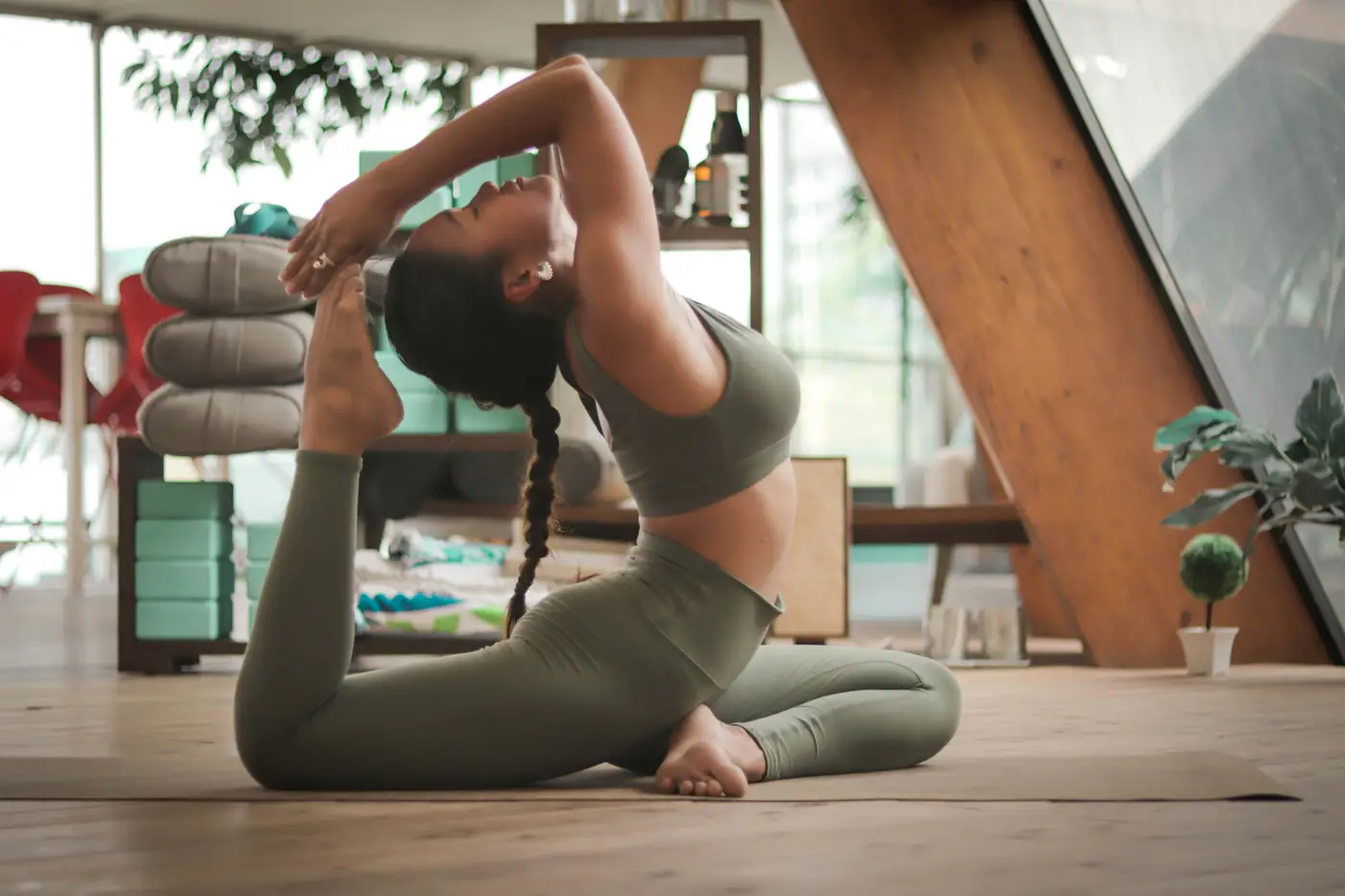 A woman practising yoga in a bright room